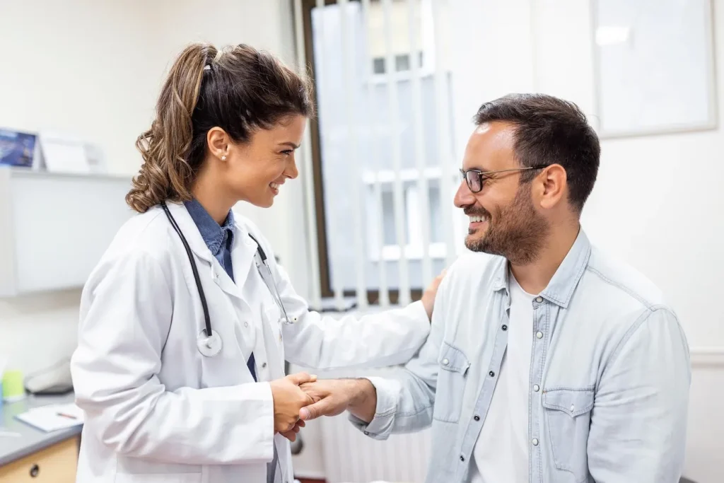 doctor and patient shaking hands during a check-up