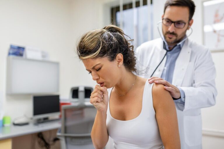 young-female-patient-clinic-suffered-from-pneumonia-she-is-coughing-doctor-listens-wheezing-lungs-with-stethoscope