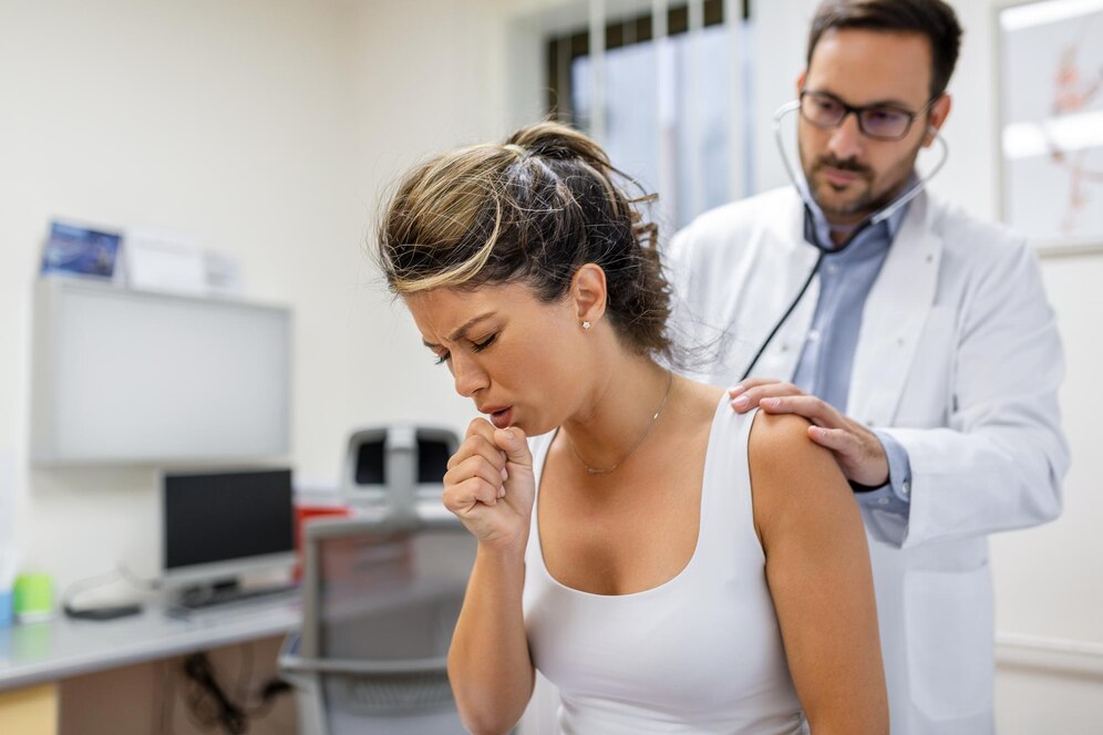 young-female-patient-clinic-suffered-from-pneumonia-she-is-coughing-doctor-listens-wheezing-lungs-with-stethoscope